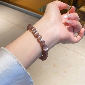 Detailed view of lavender cat eye stone bracelet with decorative silver metal accents