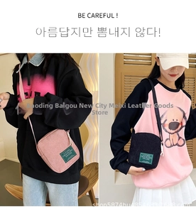 Detail of pink and black corduroy crossbody bags showing fabric texture and woven labels