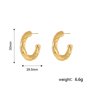 Detail view of gold C-shaped earrings with quilted texture and 30mm size dimensions