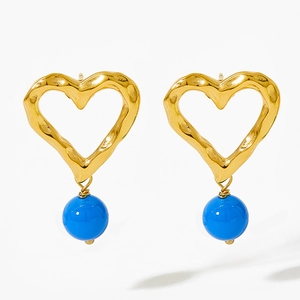 Golden wavy heart-shaped hoop earrings with blue agate drop beads on a white background