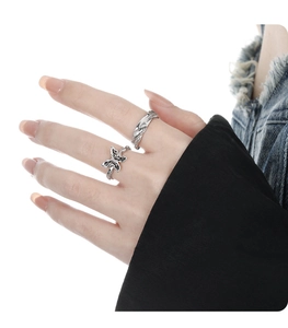 Detail of vintage silver adjustable rings with butterfly motif and twisted weave texture