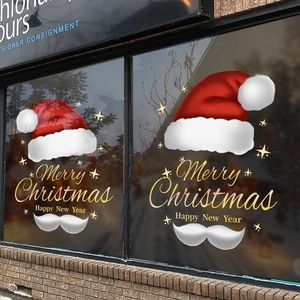 Christmas window decals with red Santa hats and golden Merry Christmas festive lettering