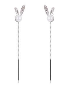 Detailed view of silver rabbit ear tassel earrings with white pearls and long chains