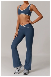 Detail of cross high waist yoga pants and contrast v-neck sports bra in misty blue