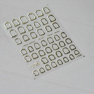 Macro detail of 3D embossed gold geometric nail art stickers with metallic texture