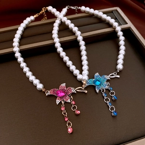 Detail of French vintage pearl necklaces with rhinestone flower pendants and tassels