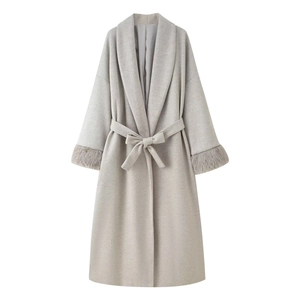Detail of grey wool coat showing elegant belted waist and luxurious faux fur cuffs