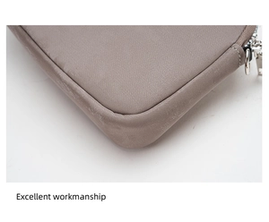 Detailed macro view of nylon stitching and metal zipper on the coffee quilted laptop sleeve
