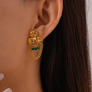 Vintage gold flower drop earrings with malachite beads and pearls on model