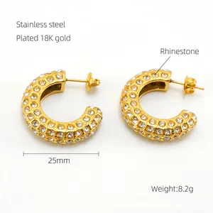 Detail of 25mm C-shaped 18K gold plated stainless steel earrings with rhinestones