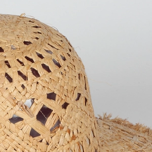 Bohemian hollow straw hat with a natural woven diamond mesh pattern for summer beach wear