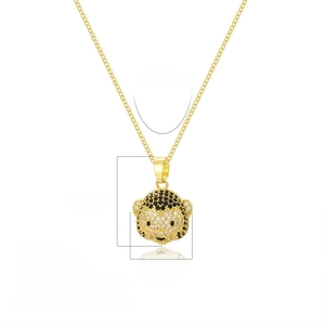 Detail of 18k gold plated monkey pendant with black and clear zircon stone settings