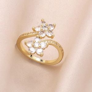 Adjustable gold flower ring with sparkling zircon stones on an elegant silk background