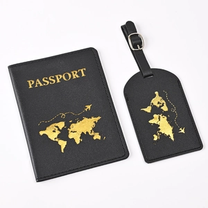 Detail of black PU leather passport holder and luggage tag with gold world map pattern
