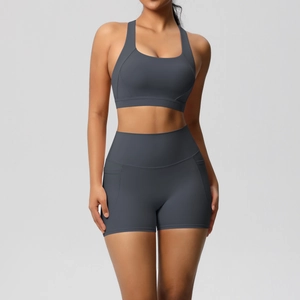 Detail of high-waist yoga shorts with functional side pocket in charcoal grey matte fabric