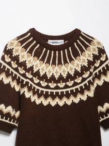 Detail of Fair Isle pattern and textured knit on brown buttoned cardigan sweater