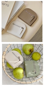 Detailed view of mini荔枝 texture coin purses in khaki, off-white, and green colors