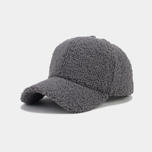 Close-up of thick dark grey faux shearling baseball cap showing fuzzy fleece texture