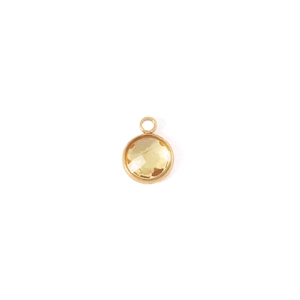Detail of 7mm gold-plated birthstone pendant with faceted yellow crystal for DIY jewelry