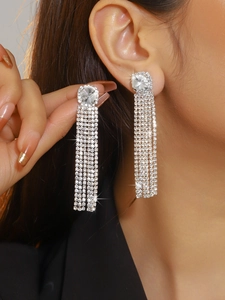 Detailed view of silver luxury tassel earrings with sparkling rhinestones and long fringe