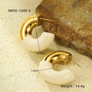 Detail view of 18k gold hoop earrings with cream enamel finish and dimensions