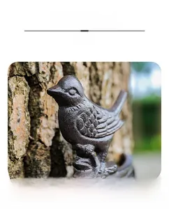 Detailed close-up of a cast iron bird bell with vintage texture and rustic finish