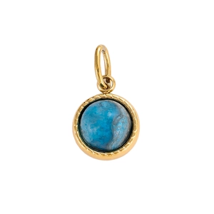 Macro view of a round gold pendant featuring a vintage polished blue natural stone