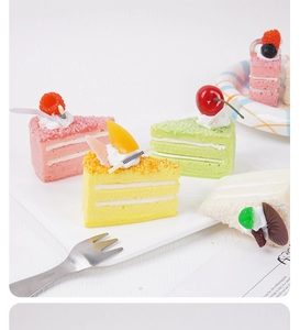 Detailed view of artificial triangle mousse cake slices with cream texture and fruit topping