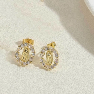 Macro detail of 14K gold plated Virgin Mary stud earrings with sparkling cubic zirconia