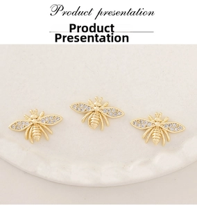 Detailed view of gold bee pendant accessories with white cubic zirconia inlay