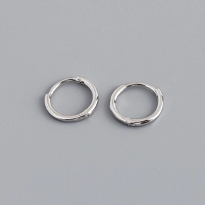 Macro view of polished 925 sterling silver hoop earrings with secure click-top closure