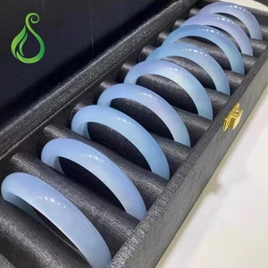 Nine light blue Brazilian agate chalcedony bangles arranged in a black display box