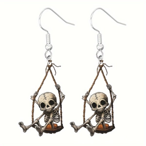 Detailed view of Halloween skull on a rope swing with pumpkin accent acrylic earring