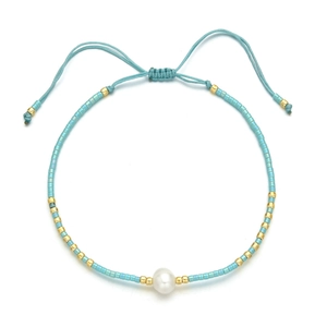 Close-up of bohemian beaded bracelet with freshwater pearl and adjustable sliding knot