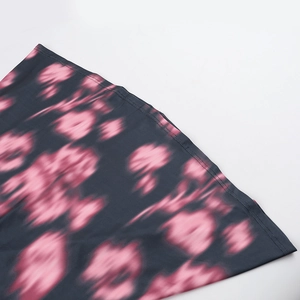 Gros plan détaillé du tissu gris foncé avec motif tie-dye rose et coutures de qualité