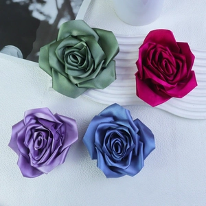Detail of 11cm handmade fabric roses in green, magenta, purple and blue for DIY accessories