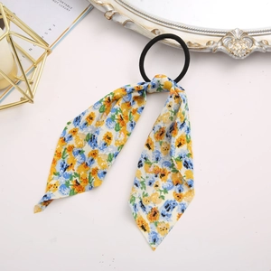 Detail of floral ribbon hair tie with yellow and blue patterns on high-elastic band