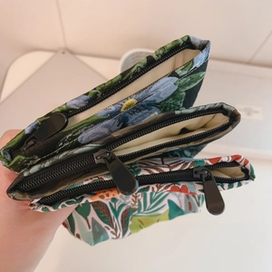 Mini jacquard fabric cosmetic bags with floral patterns and black zipper closure