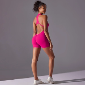 Deep v-back detail of high-stretch hot pink yoga jumpsuit with scrunch butt lifting design
