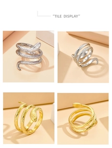 Detailed view of the spiral snake ring showing fine scale texture in gold and silver