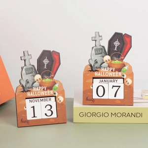 Detail of wooden Halloween countdown calendar featuring tombstone and skull decor