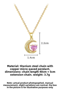 Detailed view of gold crescent moon pendant with pink heart stone and zircon pavé