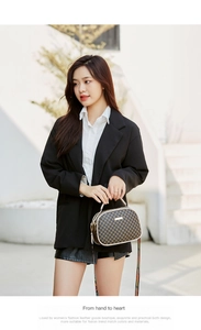 Close-up of geometric patterned small square bag with colorful woven shoulder strap
