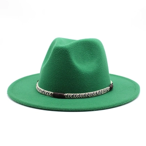 Detail of emerald green wool fedora hat featuring a woven decorative band and texture