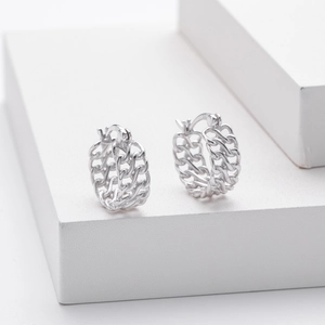 Detailed macro view of S925 sterling silver stamp on woven chain hoop earrings