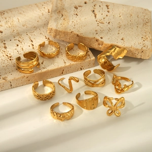 Detailed set of gold titanium steel rings with textured hammered and woven patterns