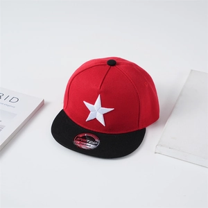 Detail of red and black kids baseball cap featuring white star embroidery and flat brim