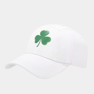 Close-up of green clover embroidery on a breathable white quick-dry baseball cap
