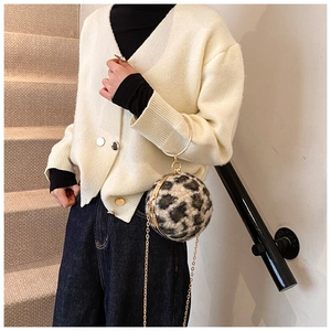 Detail of leopard print plush sphere bag with gold ring handle and chain strap