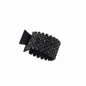 Detail of black alloy ponytail clip with pavé rhinestones and textured non-slip handle